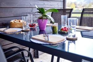 a table with plates of food and a plant on it at Heimatliebe in Garmisch-Partenkirchen
