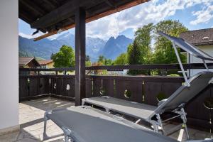 a balcony with a bench and a view of mountains at Heimatliebe in Garmisch-Partenkirchen