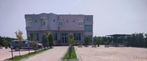 a large building with a car parked in front of it at Reardi in Durrës