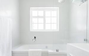 a white bathroom with a tub and a window at Art House in Stellenbosch +53 photos