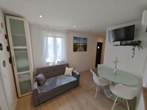 a living room with a couch and a table at Apartment Luka in Matulji