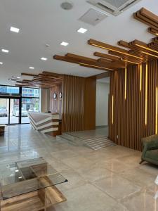 a lobby with a couch and a glass table at Aqua Batumi 47 in Batumi