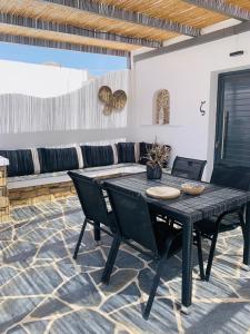 a black table and chairs in a room with a couch at Mazi stin Io in Ios Chora