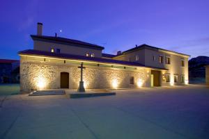 a large building with lights on it at night at Hotel La Vida Spa in Aldeayuso