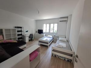 a large white room with a bed and a desk at NoAr Apartment Rijeka in Rijeka +32 photos