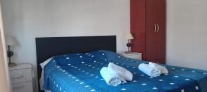 a blue bed with two white pillows on it at LA ÑATA in Concepción del Uruguay