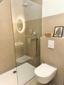 a bathroom with a toilet and a glass shower at Olive Garden in Promajna +14 photos