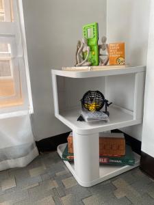 a white shelf with toys on it in a room at Spacious 2-Level 2BR Cozy Apartment in Naga +6 photos