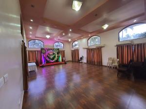 a large room with a dance floor and a stage at The Pentacon A Resort in Canacona