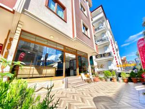 a store front of a building with tables and chairs at Parfe Apart in Trabzon