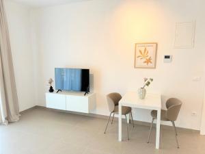 a living room with a tv and a table at Olive Garden in Promajna