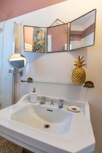 a bathroom with a white sink and two mirrors at Les deux clefs acte 2 in Mont-de-Marsan