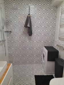 a bathroom with a black umbrella on a wall at Nadmorskie Apartamenty w Gąskach in Gąski +12 photos