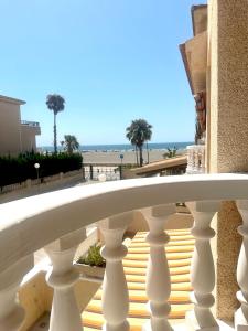 a white balcony with a view of the beach at Under the Spanish Sun - House on the beach in Santa Pola