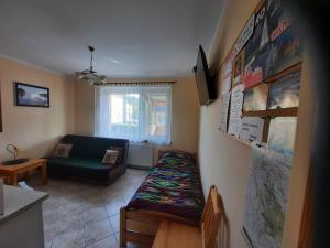 a living room with a couch and a table at Pokoje U Elizabeth in Augustów