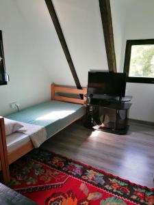 a bedroom with a bed and a piano in a room at Koliba TAMAN in Konjic +27 photos