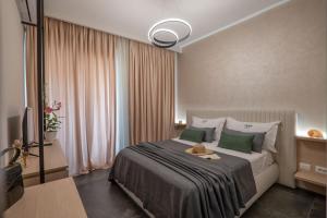 a bedroom with a bed with a teddy bear on it at Villa Green Garden in Sarandë