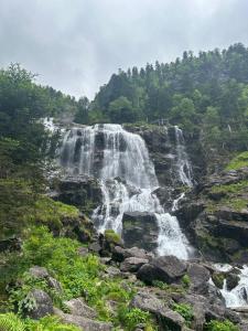 a waterfall on the side of a mountain at Appartement Le SKICOSY à Guzet Neige in Ustou