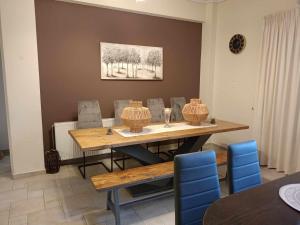 a dining room with a wooden table and chairs at Comfortable apartment in Kiato in Kiaton