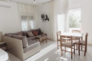 a living room with a couch and a table at Villa Melodia Xhek in Ksamil