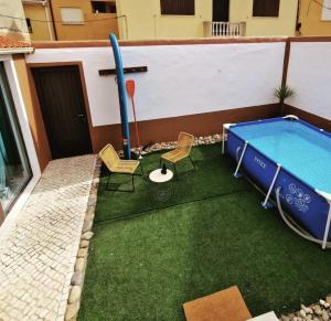 a pool on the roof of a building with chairs and a table at Loft beach in Vieira de Leiria