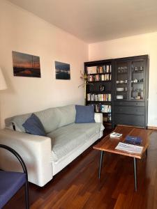 a living room with a couch and a coffee table at Apartment Aurelia in Muggia +6 photos