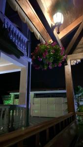 a balcony with flowers hanging from a ceiling at Guest House Pulake in Berat