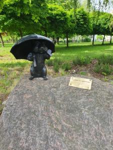 a statue of a bear holding an umbrella at Apartament Daria in Jaworzno