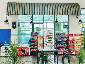 a store front of a grocery store with a table in it at Cyberjaya - Netflix - Disney - Wifi in Cyberjaya +28 photos