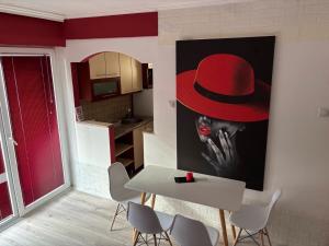 a painting of a man in a red hat on a wall at Ako odam vo Bitola in Bitola