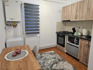 a kitchen with a wooden table and a stove at Saturn Studio in Braşov +18 photos