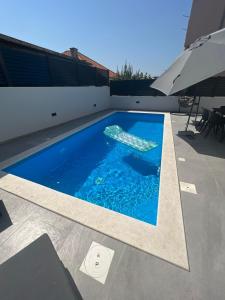 a swimming pool on the roof of a house at Residence Doli Pool in Vrsi