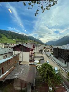 a view of a town with mountains in the background at Trilocale nel centro storico di Bormio in Bormio