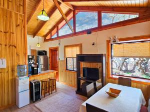 a kitchen with wooden walls and a large window at Lodge Ancar Atacama in San Pedro de Atacama
