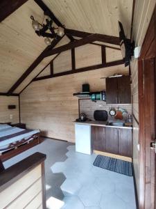 a kitchen with wooden walls and a counter in a room at Апартаменти У Кузьмича однокімнатні студіо in Mykulychyn