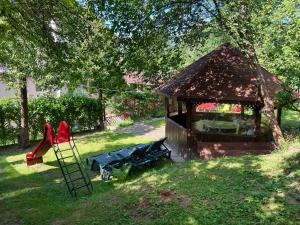 a gazebo with a bench and a playground at Prestige ApartHotel Brasov in Braşov