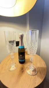 two empty wine glasses and a bottle on a table at Luxury Haven in Saronida