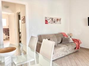 a living room with a couch and a table at Villa Etienne - Key to Villas in Valledoria