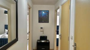 a hallway with a mirror and a room with a bed at City Centre 1 Bedroom Cozy Apt - With Balcony in Birmingham