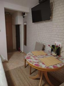 a living room with a table and a tv at Apartment Martea in Split