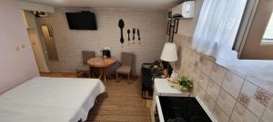 a small room with a bed and a table at Apartment Martea in Split