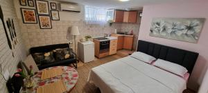 a small bedroom with a bed and a kitchen at Apartment Martea in Split