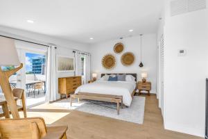 a white bedroom with a bed and a balcony at Gorgeous coastal PH with Large Private Terrace in Miami Beach