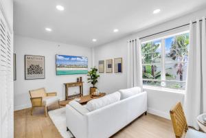 a living room with a white couch and a window at Gorgeous coastal PH with Large Private Terrace in Miami Beach