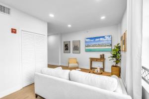 a white living room with a white couch at Gorgeous coastal PH with Large Private Terrace in Miami Beach +35 photos