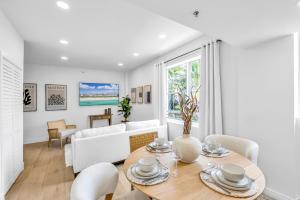 a living room with a table and chairs and a couch at Gorgeous coastal PH with Large Private Terrace in Miami Beach