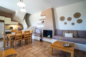 a living room with a couch and a table at Belvedere Karystos in Karistos