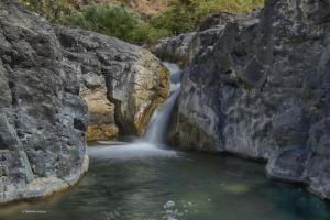 a waterfall in the middle of a rocky river at Casa OXENA in Militello in Val di Catania +2 photos