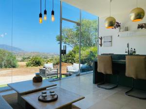 a living room with a table and a large window at La Careza De Mijas - Adults Only in Mijas