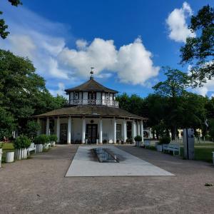 a building with a clock tower in a park at FeWo Dreiseitenblick Komfort mit 2 Schlafzimmern in Bad Doberan